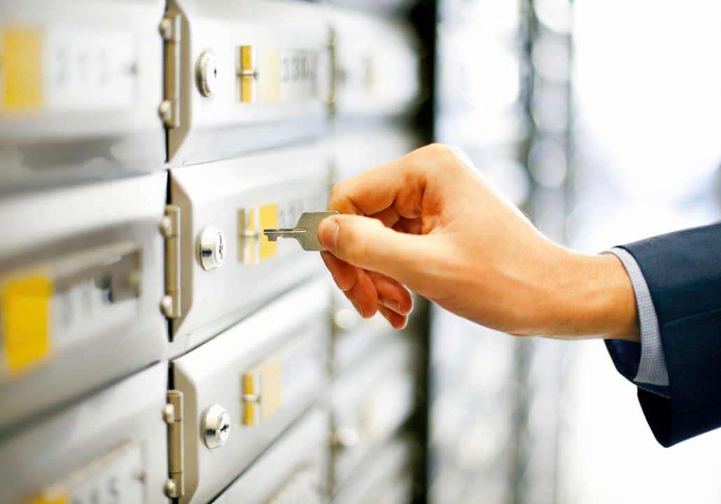 hand unlocking bank deposit box with key