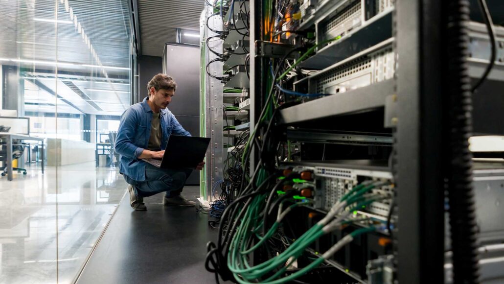 IT manager looking at server